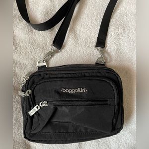 Bagallini brand. Small crossbody bag. Can also be a waist bag. Lots of pockets.